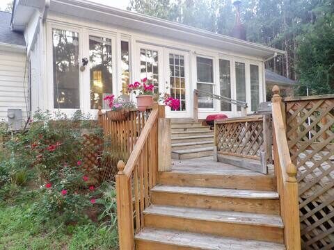 Deck seating overlooking the private pond at Waterside Lodging